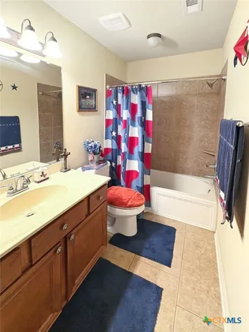 a bathroom with a sink mirror vanity and bathtub