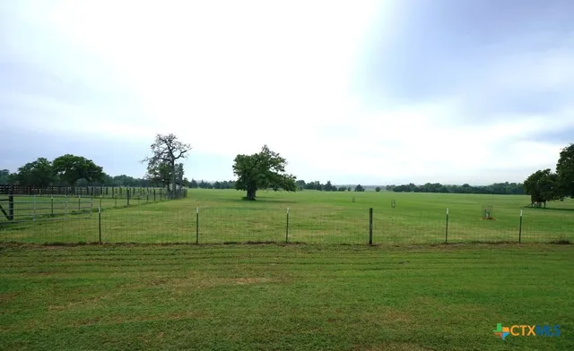 a view of a lake with houses in the back