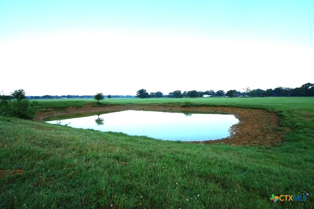 a view of a lake with houses in back
