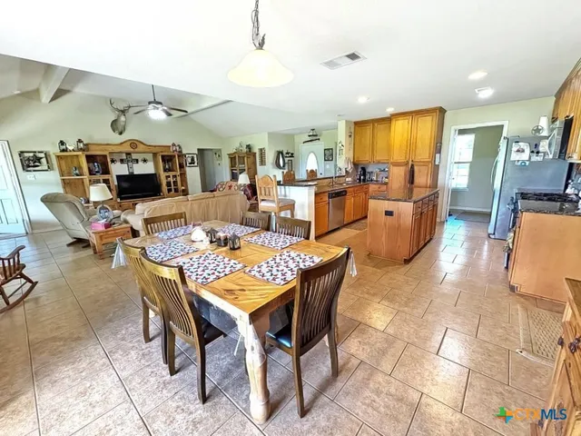 a living room with lots of furniture and kitchen view
