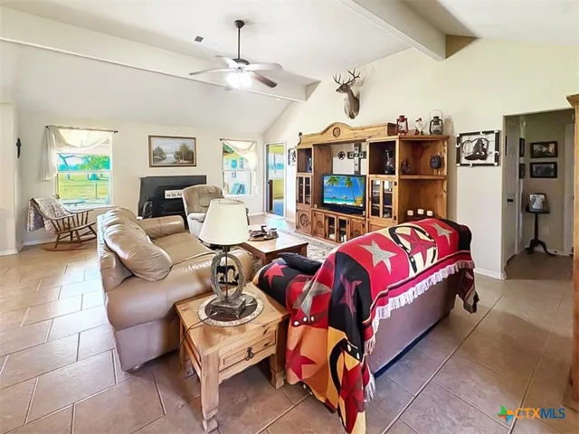a bedroom with furniture a flat screen tv and a couch