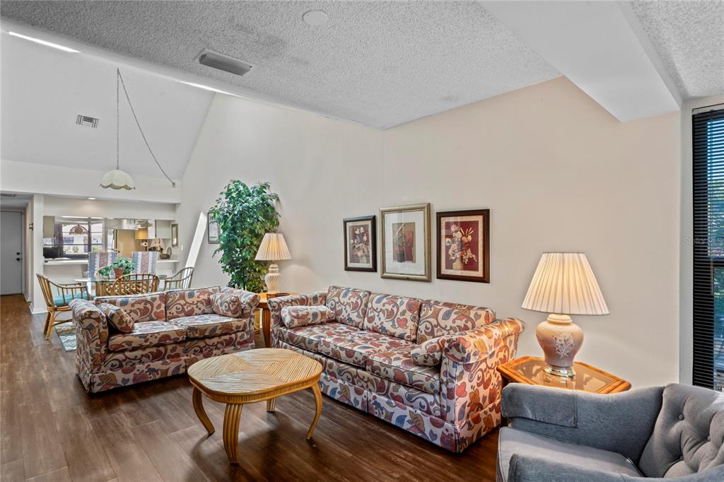 9218 Championship Lane, Unit 3 New Port Richey, FL 34655 - Photo 11 of 52 a living room with furniture and a wooden floor