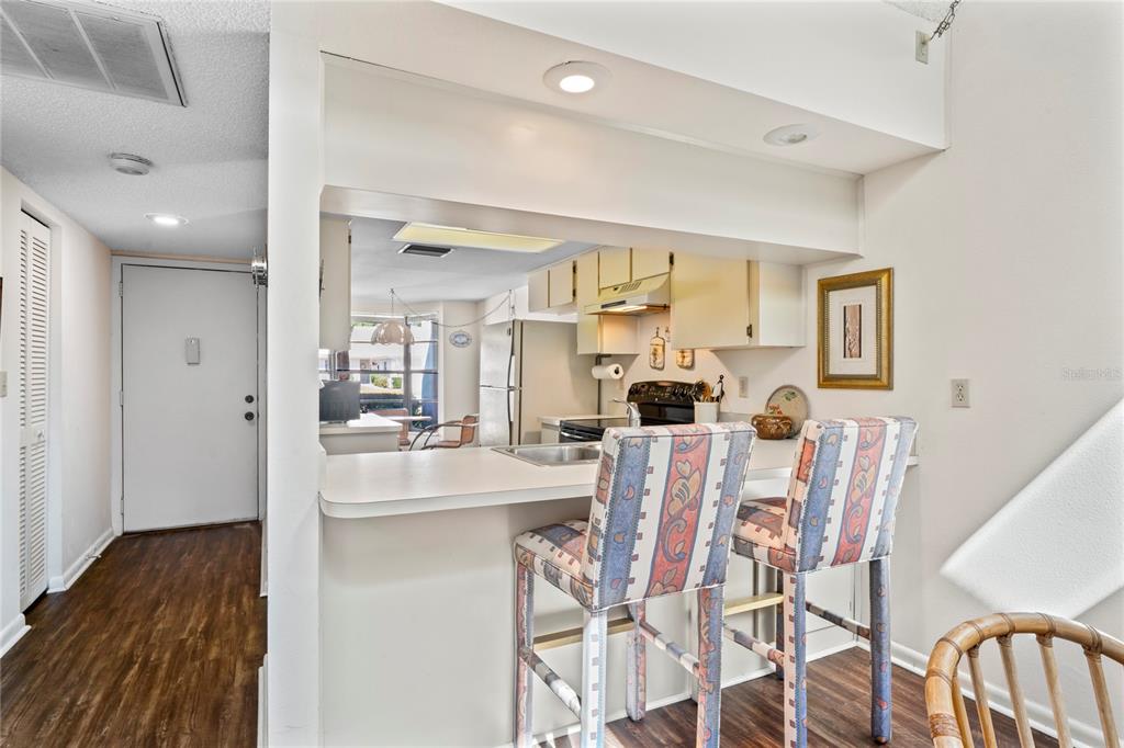 9218 Championship Lane, Unit 3 New Port Richey, FL 34655 - Photo 14 of 52 a view of a dining room with furniture and wooden floor