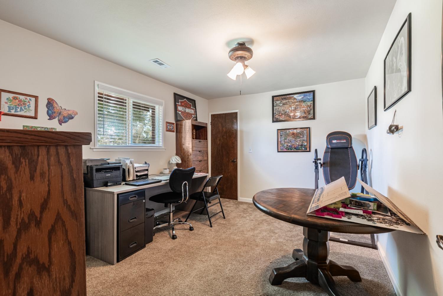 16993 Jennifer Court Madera, CA 93636 - Photo 18 of 55 a view of a workspace with furniture and a window