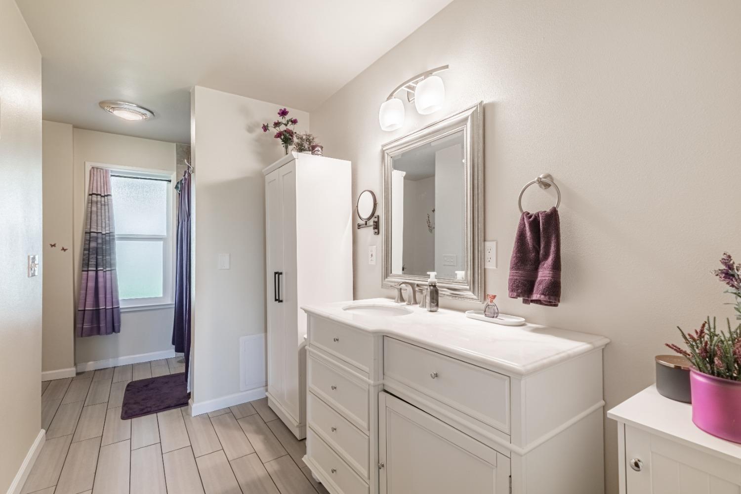 16993 Jennifer Court Madera, CA 93636 - Photo 21 of 55 a bathroom with a double vanity sink mirror and shower