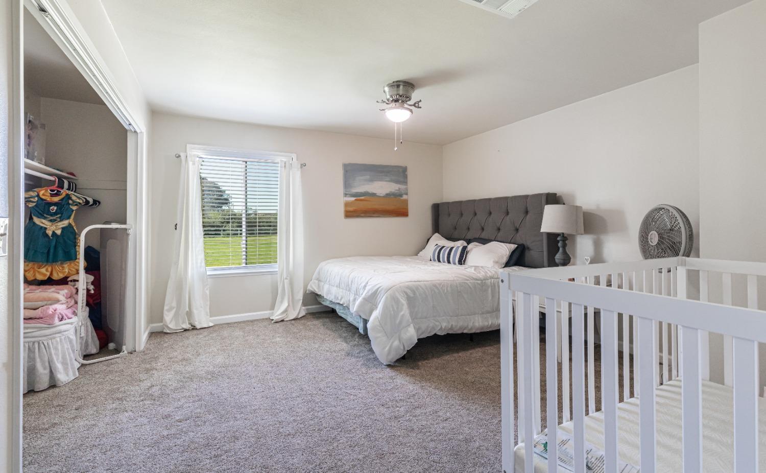 16993 Jennifer Court Madera, CA 93636 - Photo 22 of 55 a bedroom with bed and a window