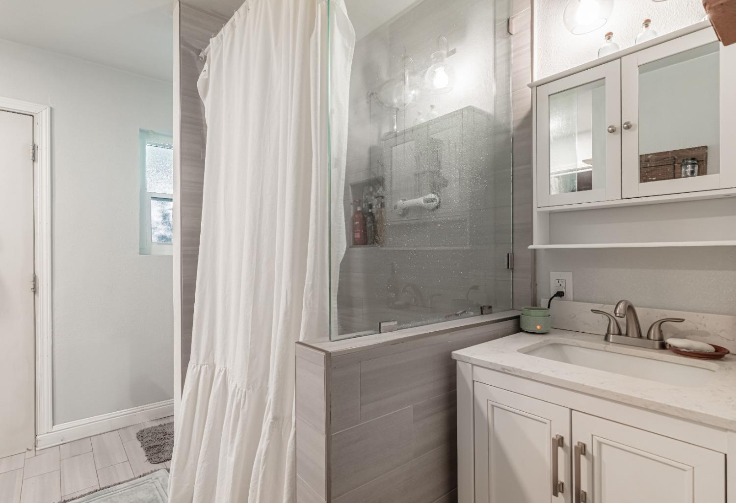16993 Jennifer Court Madera, CA 93636 - Photo 24 of 55 a bathroom with a sink and a mirror