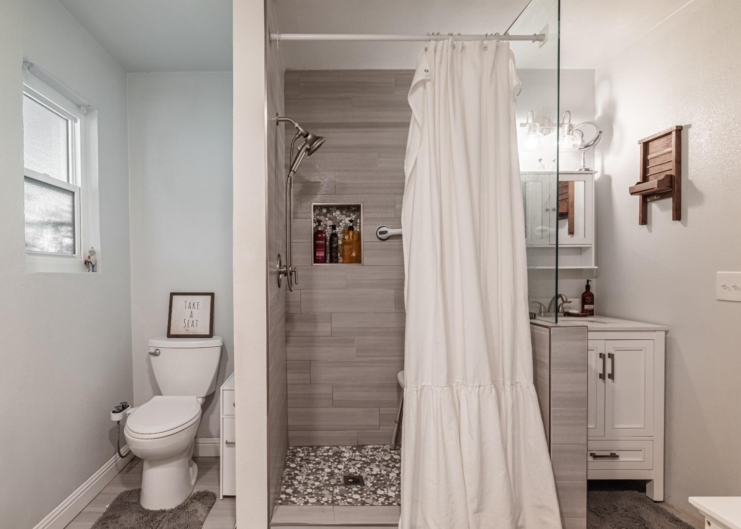 16993 Jennifer Court Madera, CA 93636 - Photo 25 of 55 a bathroom with a toilet sink and shower