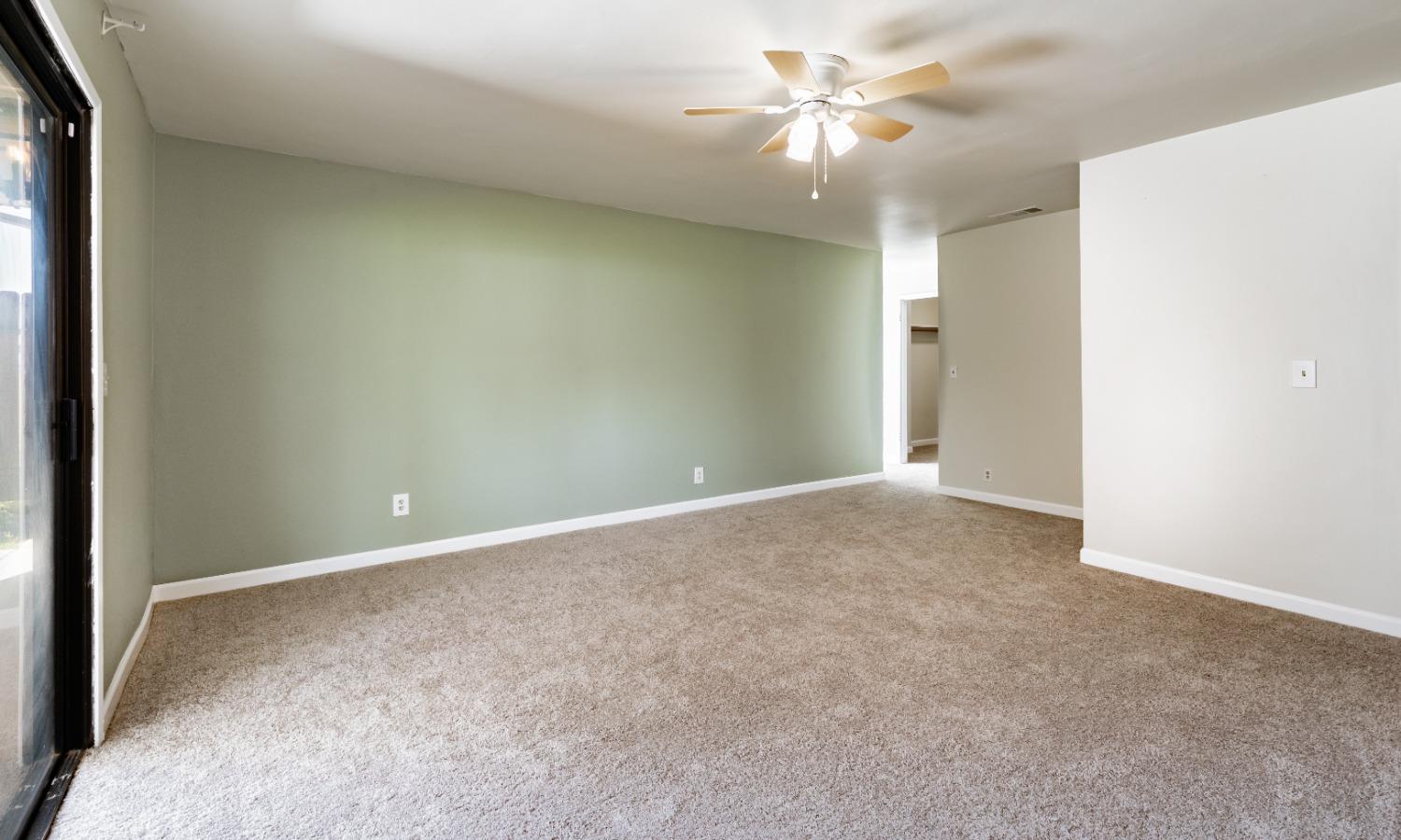 16993 Jennifer Court Madera, CA 93636 - Photo 28 of 55 an empty room with a ceiling fan and a window