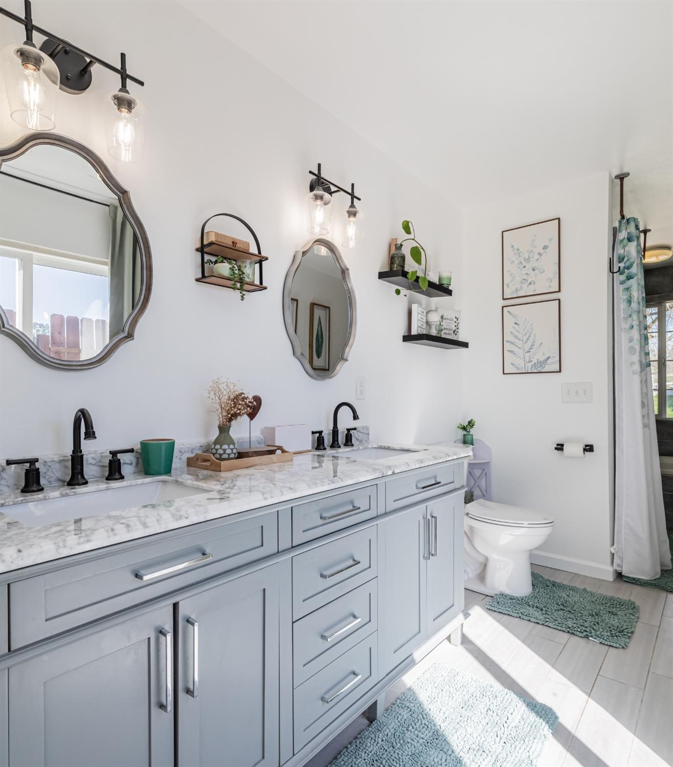 16993 Jennifer Court Madera, CA 93636 - Photo 30 of 55 a bathroom with a granite countertop sink mirror and toilet