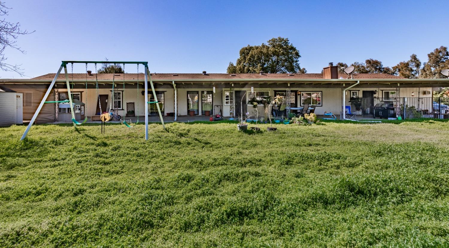 16993 Jennifer Court Madera, CA 93636 - Photo 37 of 55 a view of a house with a yard