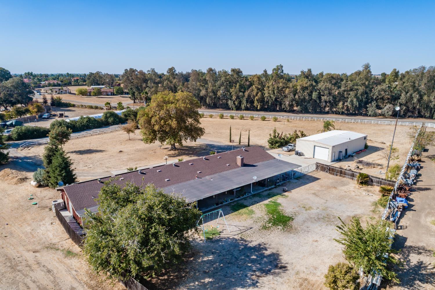 16993 Jennifer Court Madera, CA 93636 - Photo 47 of 55 an aerial view of a house with a yard and lake view