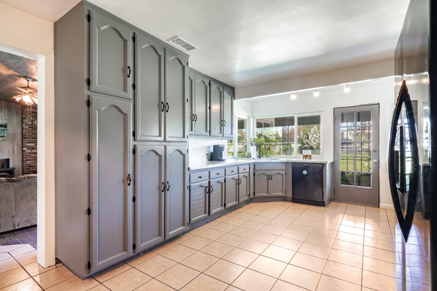 16993 Jennifer Court Madera, CA 93636 - Photo 7 of 55 a kitchen with stainless steel appliances a refrigerator and sink
