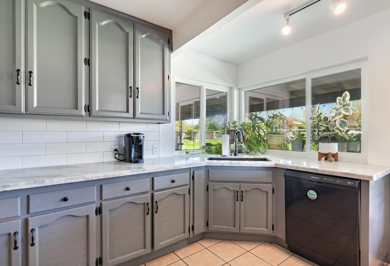 16993 Jennifer Court Madera, CA 93636 - Photo 8 of 55 a kitchen with a sink and cabinets