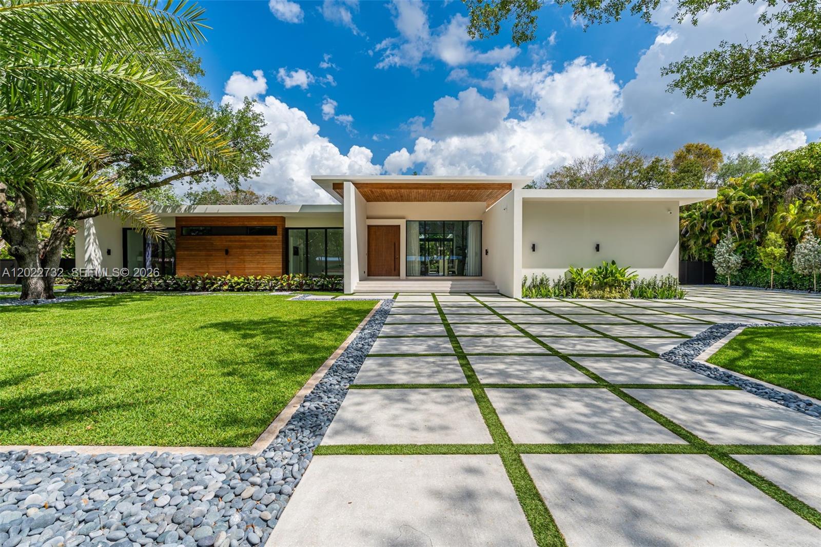 7825 Southwest 128th Street Pinecrest, FL 33156 - Photo 1 of 88 a front view of a house with a yard