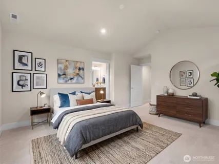 a bedroom with a bed a painting on the wall and dresser