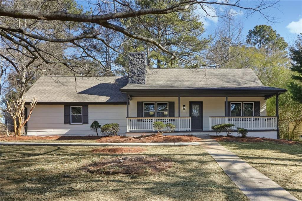 3292 Lancer Drive Powder Springs, GA 30127 - Photo 1 of 1 a view of a white house with large windows and a table and chairs