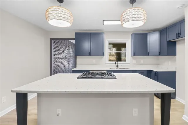 a view of a kitchen with a sink dishwasher and wooden floor