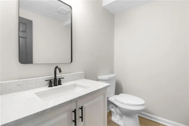 a bathroom with a sink a toilet and mirror