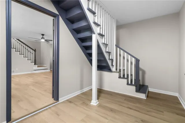 a view of a hallway with wooden floor and entryway