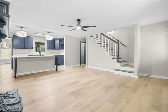 a view of a kitchen with furniture a fireplace and wooden floor