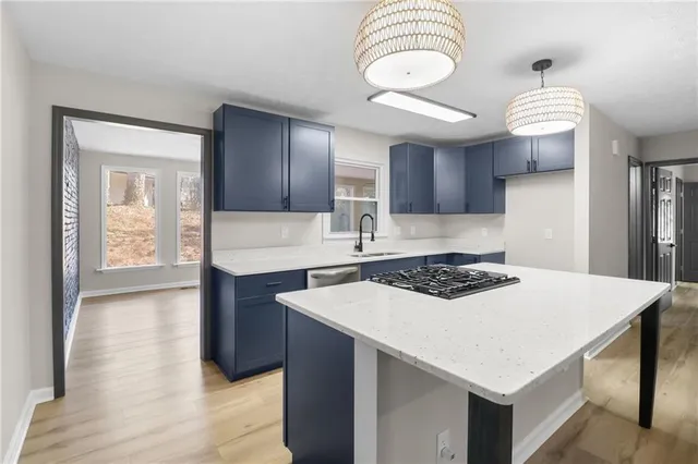 a kitchen with a stove a sink and a refrigerator