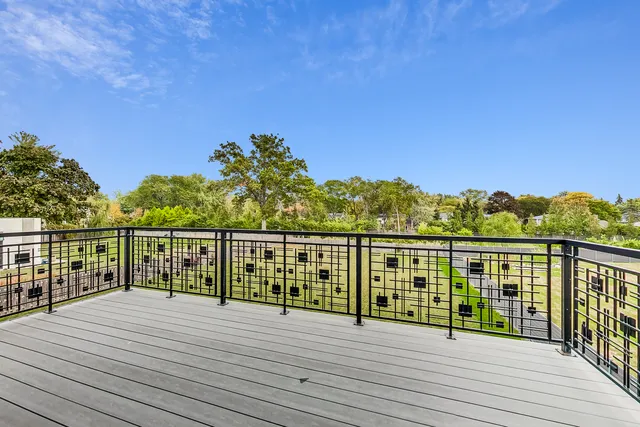 a view of a street with a house in the background