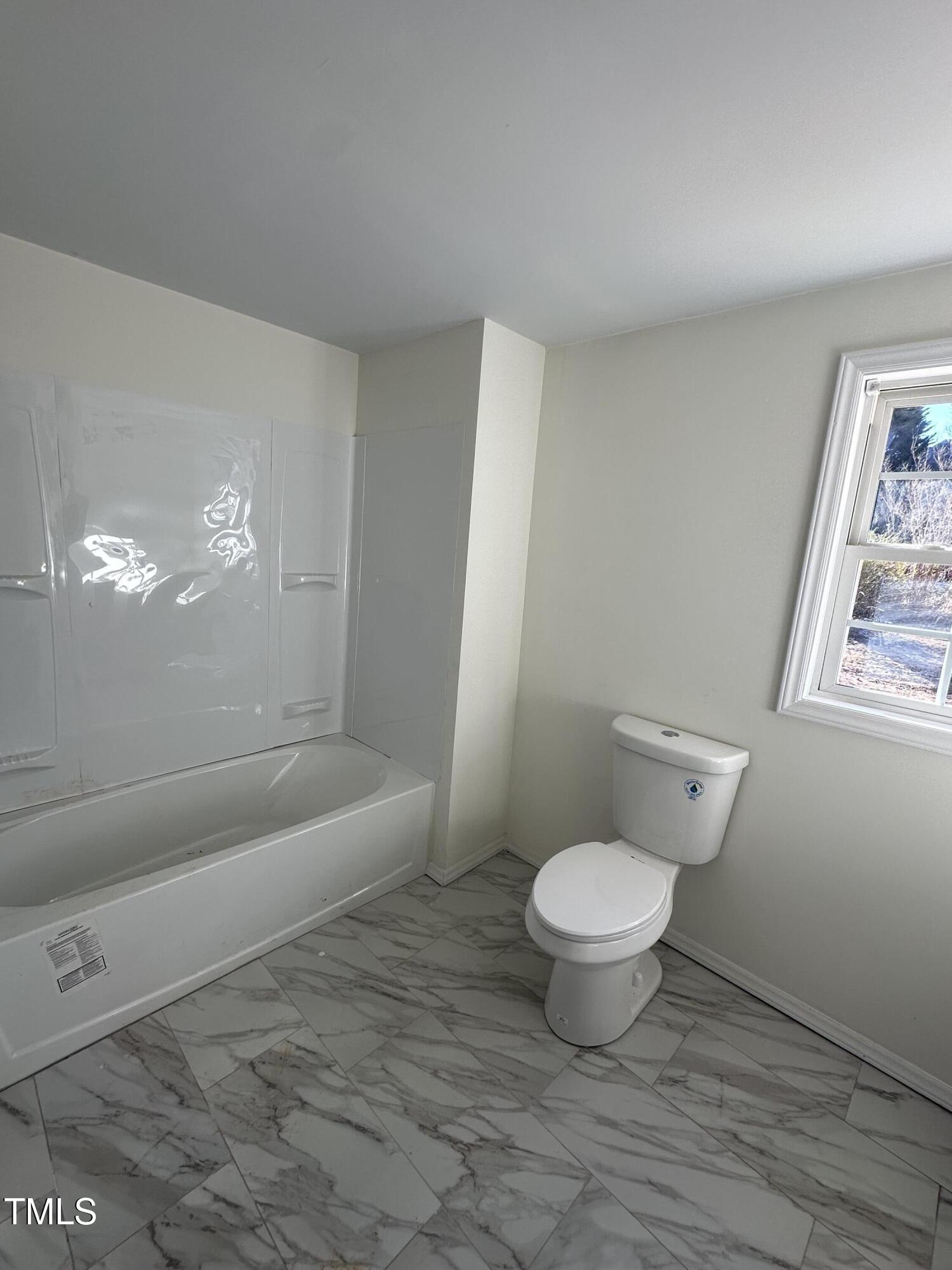8505 Ray Road Raleigh, NC 27613 - Photo 13 of 15 a bathroom with a toilet and a tub