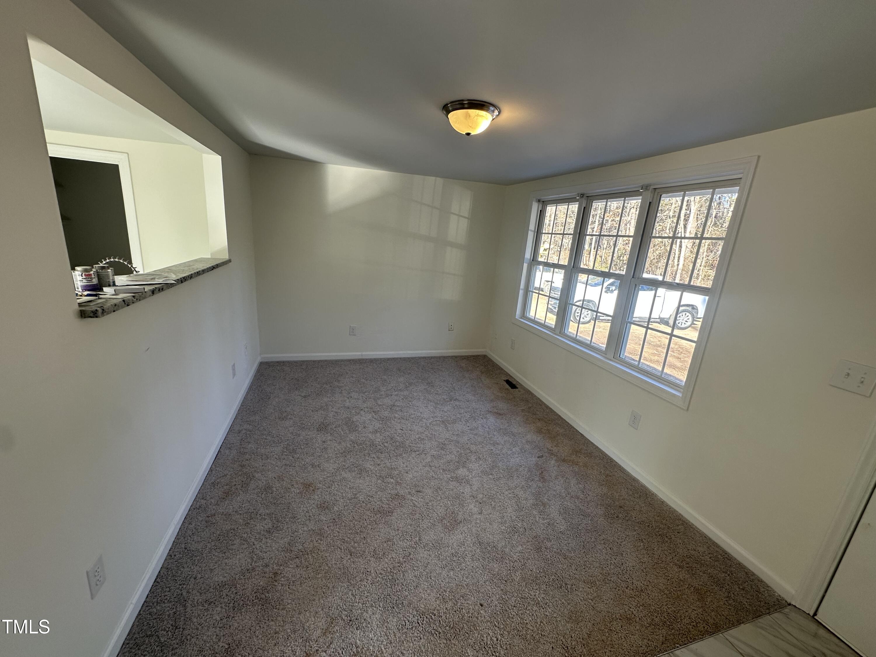 8505 Ray Road Raleigh, NC 27613 - Photo 6 of 15 a view of an empty room with a window