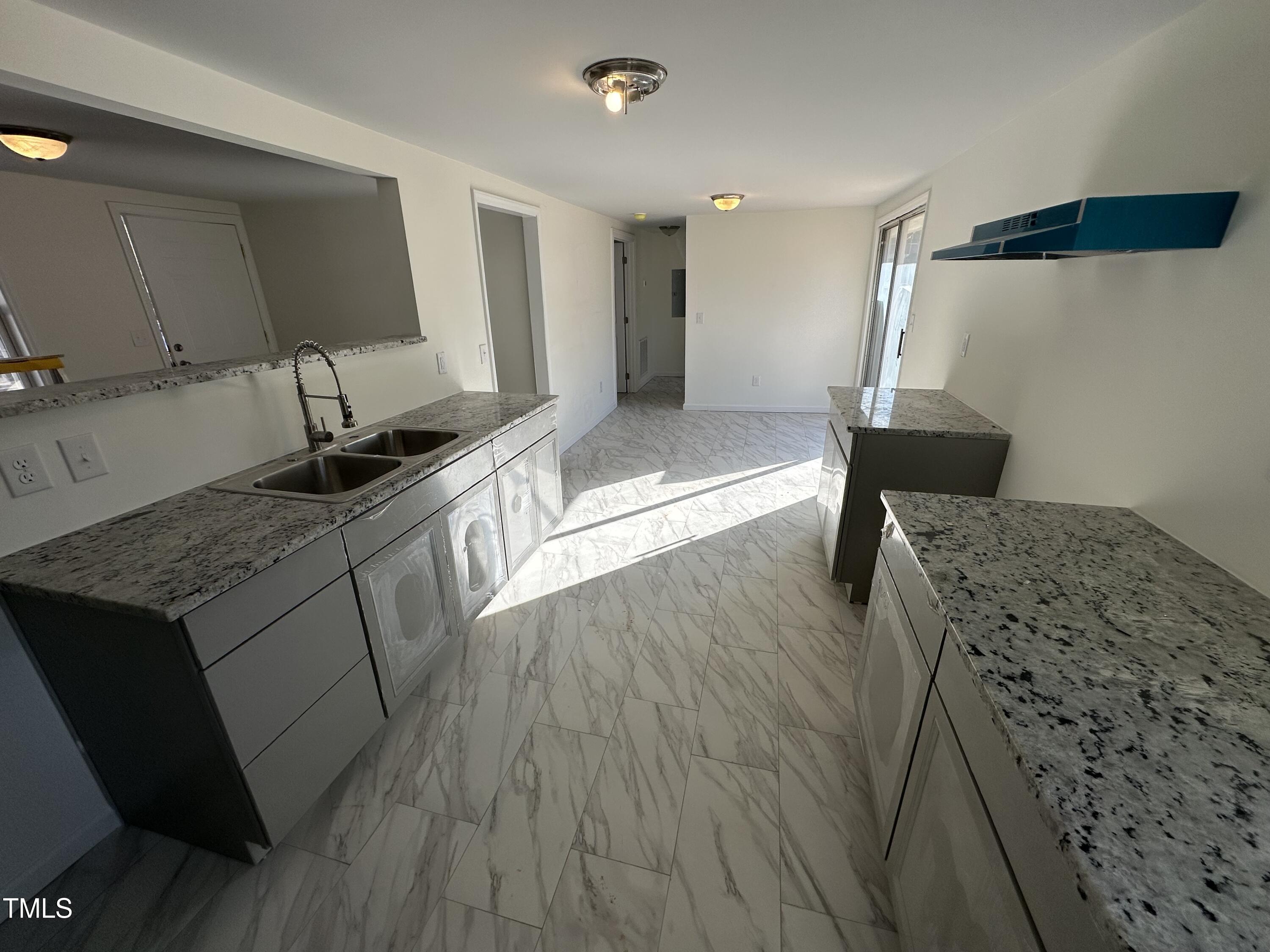 8505 Ray Road Raleigh, NC 27613 - Photo 7 of 15 a kitchen with a sink and wooden floor