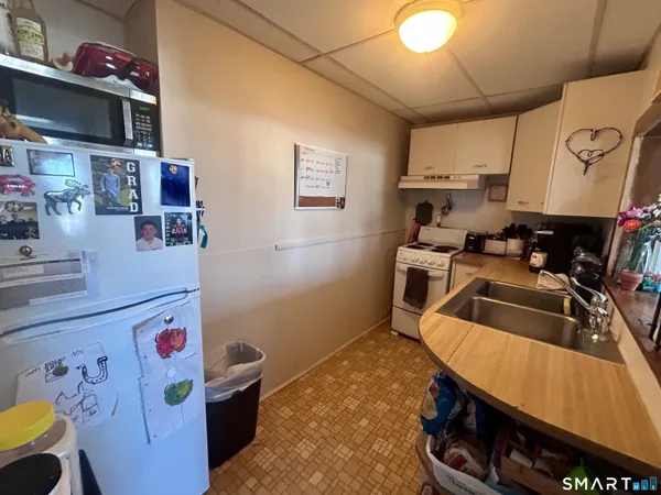 a kitchen with a refrigerator and a stove top oven