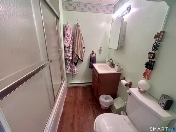a bathroom with a sink mirror vanity and toilet