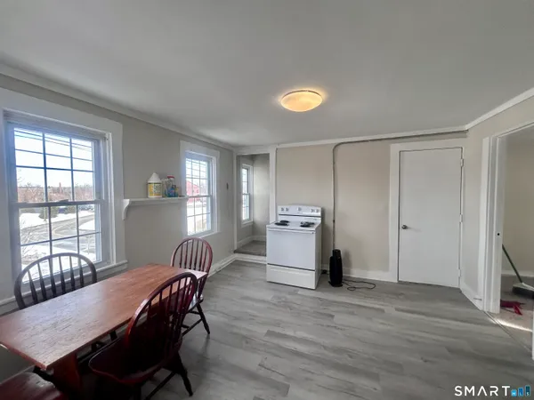 a view of a dining room with furniture and window
