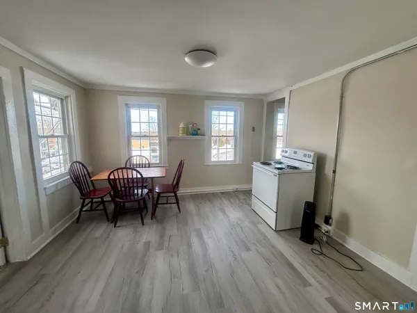 a dining room with furniture and wooden floor