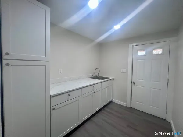 a room with a sink and cabinets