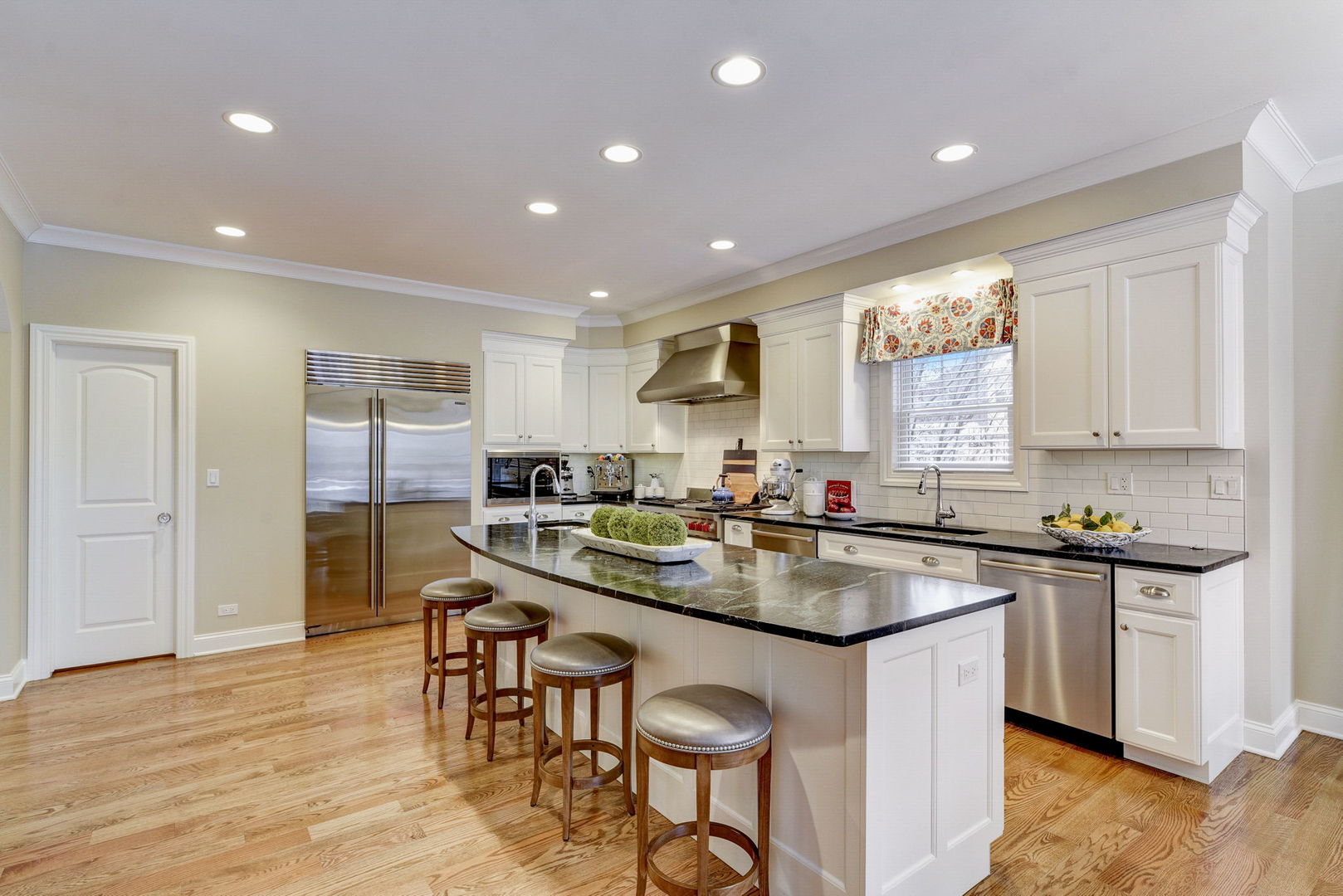 20940 West Summit Drive Kildeer, IL 60047 - Photo 13 of 62 a kitchen with stainless steel appliances granite countertop counter top space a sink cabinets and wooden floor