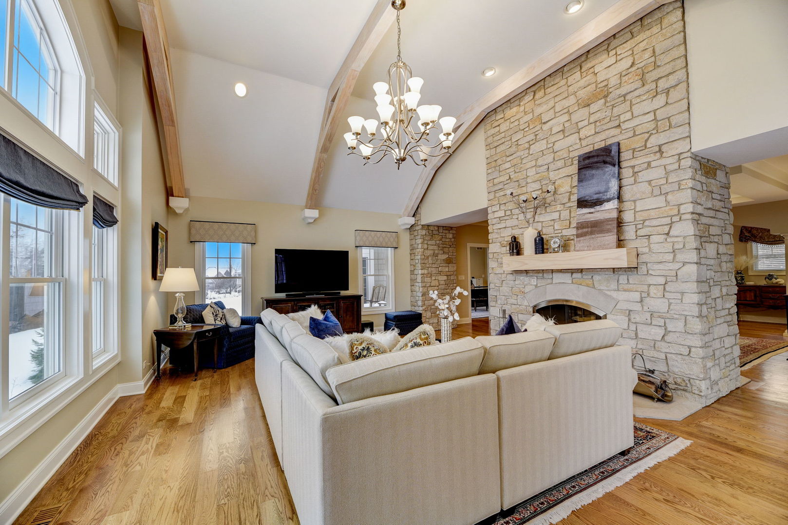 20940 West Summit Drive Kildeer, IL 60047 - Photo 19 of 62 a living room with furniture a fireplace and a chandelier