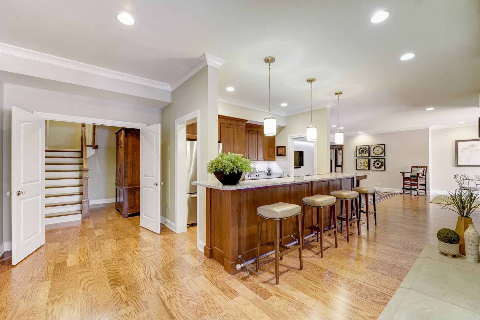 20940 West Summit Drive Kildeer, IL 60047 - Photo 38 of 62 a kitchen with stainless steel appliances kitchen island granite countertop a refrigerator a stove a dining table and chairs with wooden floor