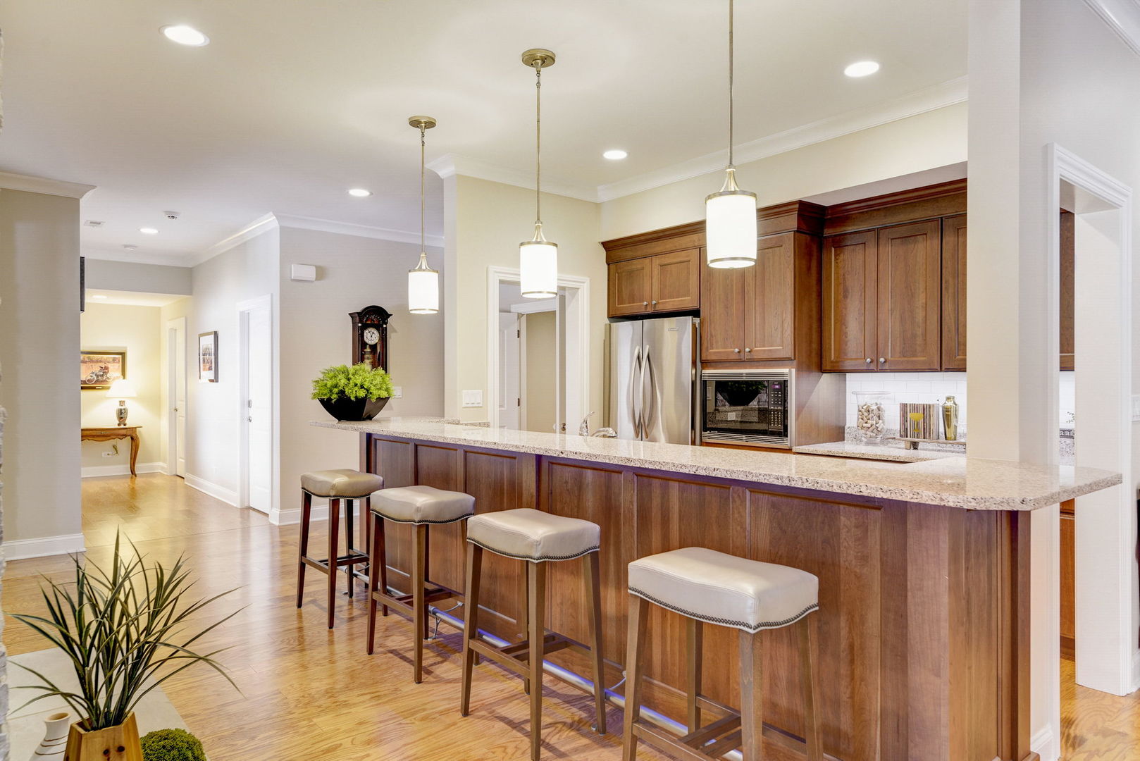 20940 West Summit Drive Kildeer, IL 60047 - Photo 41 of 62 a kitchen with stainless steel appliances granite countertop a table chairs and a refrigerator