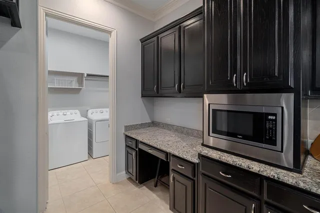 a kitchen with granite countertop a stove and a microwave