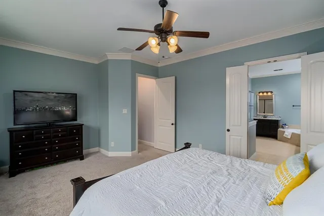 a bedroom with a bed and a dresser in it