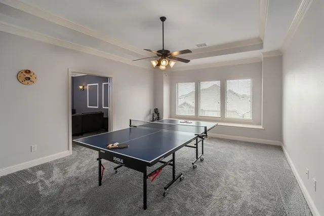 a living room with a table chairs and a window