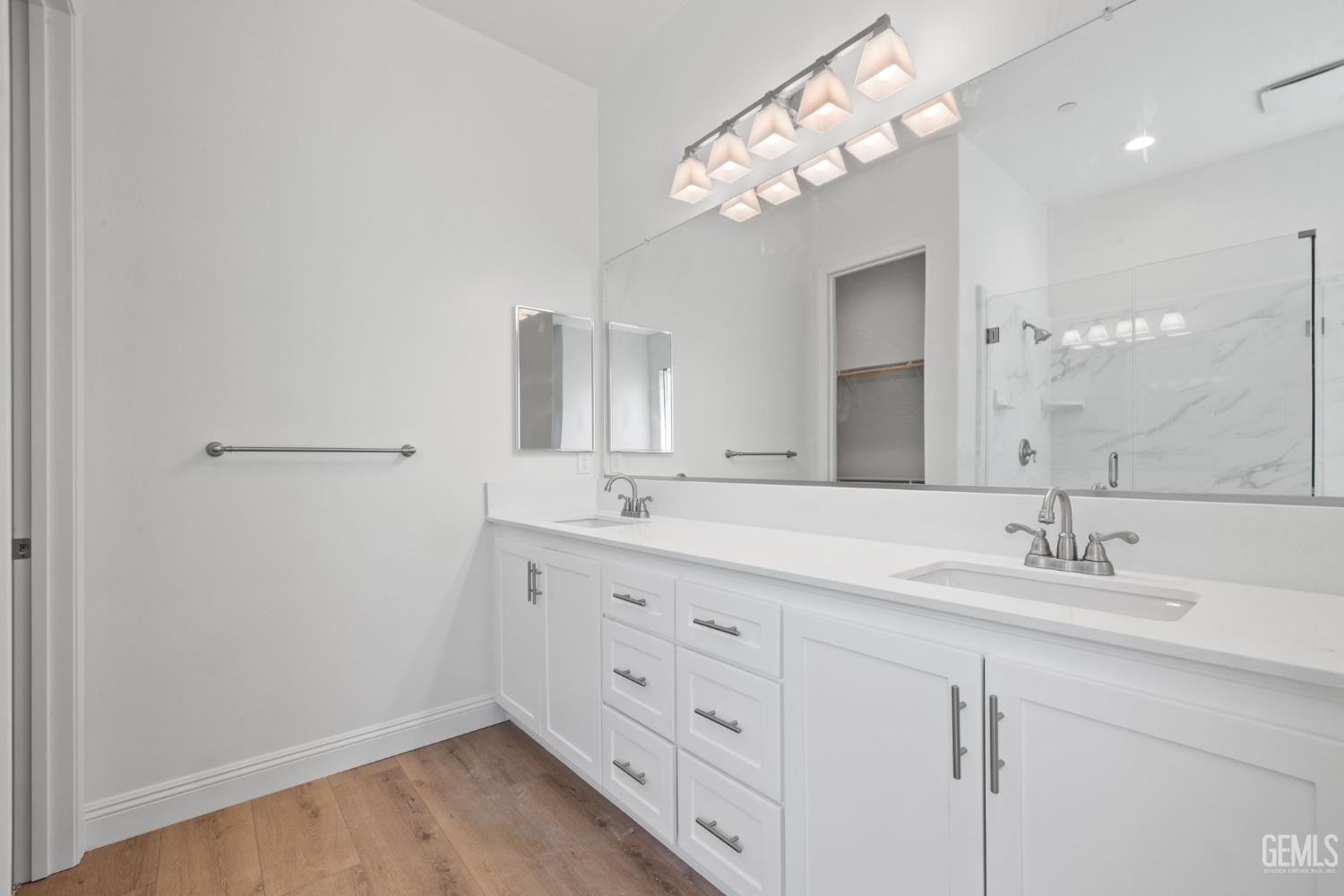 Undisclosed Address Bakersfield, CA 93314 - Photo 35 of 55 a bathroom with a double vanity sink and a mirror