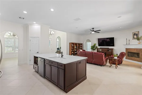 a spacious kitchen with stainless steel appliances granite countertop a sink a stove and a refrigerator