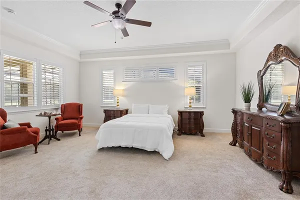 a bedroom with a bed couch and window