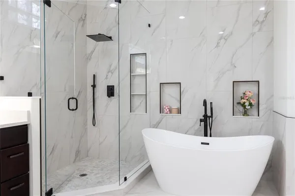 a bathroom with a sink a mirror and shower