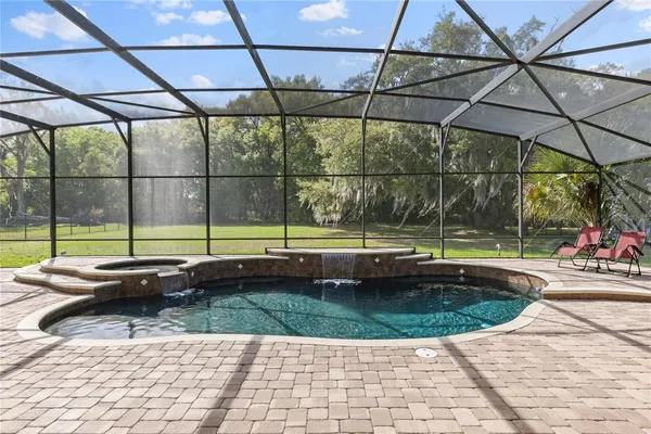 a view of swimming pool with seating space