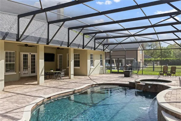 a building outdoor space with patio lots of furniture and tub