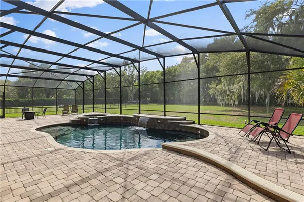 a swimming pool with outdoor seating