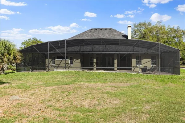 a view of a backyard with table and chairs and potted plants
